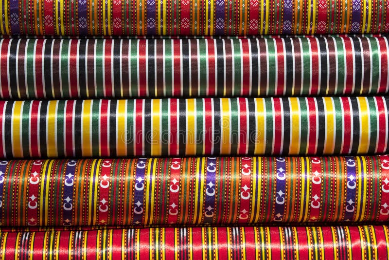 Scrolls rolls colored colorful fabric. Consumerism, clothes.
