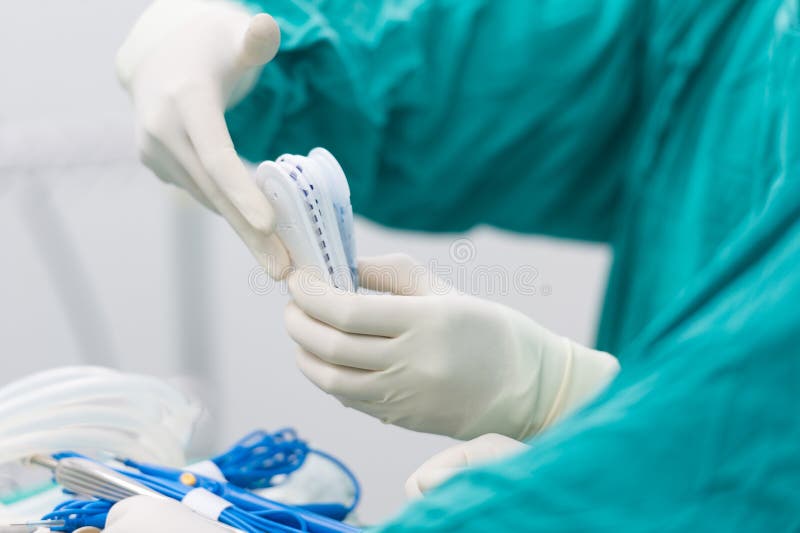 Scrub Nurse Preparing Tools for Operation Stock Photo Image of