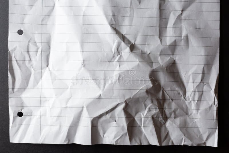 Scrunched Up, Hole Punched Sheet of Lined White Notebook Paper, on