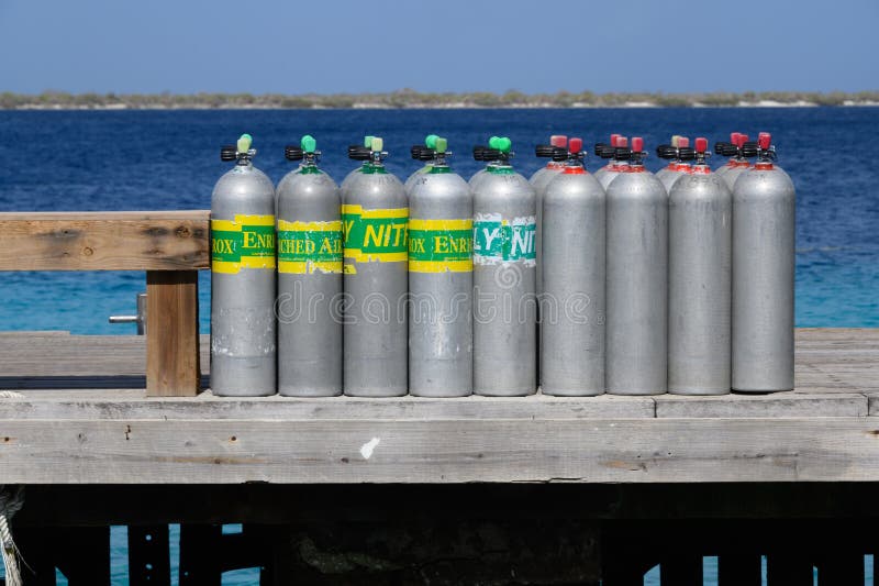 The Dutch-Caribbean scuba-diving island of Bonaire. Scuba cylinders of Nitrox Enriched Air and Air on a jetty on the Dutch Caribbean island of Bonaire in the