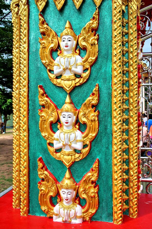Sculpture of angel at a pole in a temple in THailand stock photo Sculpture of angel at a pole in a temple in THailand stock photo