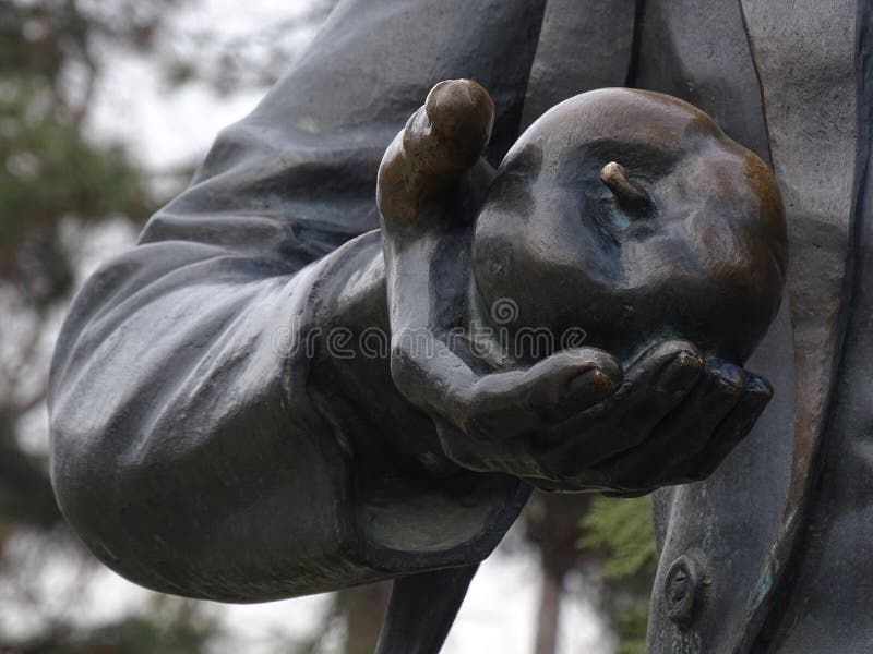 The sculpture, hand holding an apple stock photos