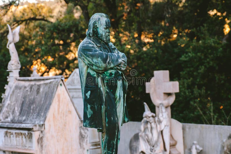 Sculpture of senior man at old cemetery. stoned statue memorial at cemetery.  All Saint`s Day. Copy space. sculpture of a woman a