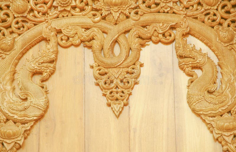 Scultura di legno con due modelli del naga sulla parete in tempio fotografia stock Scultura di legno con due modelli del naga sulla parete in tempio fotografia stock