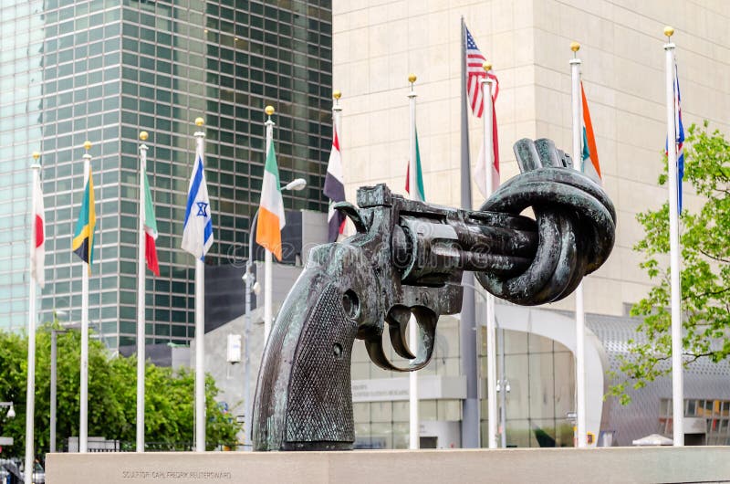 NEW YORK - MAY 28: Non Violence Sculpture at the United Nations Headquarters in May 28, 2013. The in New York, New York. A Gun tied in a knot as symbol for reaching peace, gift from the Government of Luxembourg. NEW YORK - MAY 28: Non Violence Sculpture at the United Nations Headquarters in May 28, 2013. The in New York, New York. A Gun tied in a knot as symbol for reaching peace, gift from the Government of Luxembourg