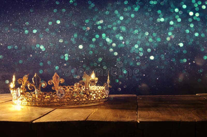 low key image of beautiful queen/king crown over wooden table. vintage filtered. fantasy medieval period. low key image of beautiful queen/king crown over wooden table. vintage filtered. fantasy medieval period