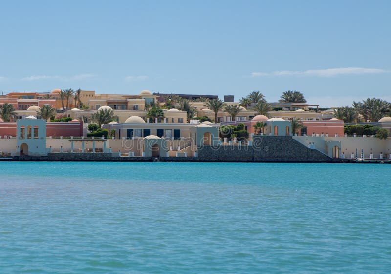 Sea beach with palms and houses in egypt.