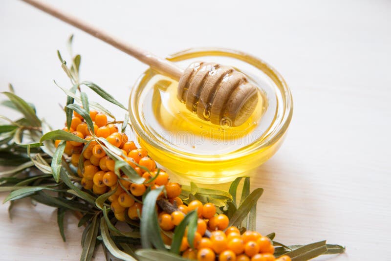 Sea Buckthorn and Honey on a Light Background. Selective Focus Stock
