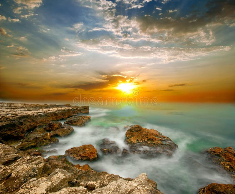 Sea cliffs and sunset over the sea