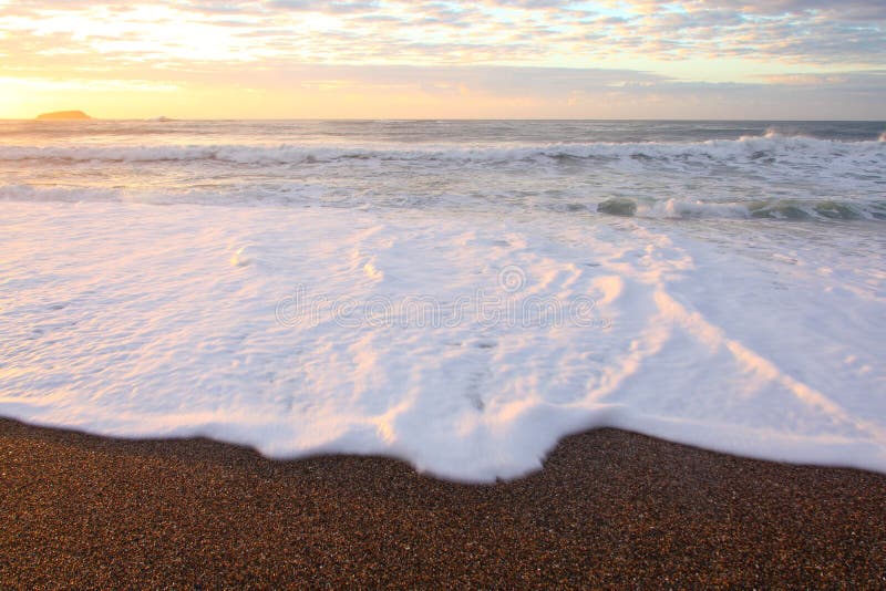 Rolling ocean surf blur at beach by sunrise stock photography Rolling ocean surf blur at beach by sunrise stock photography
