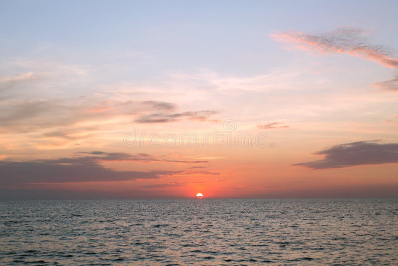 Sea pink sunset. Beautiful color clouds. royalty free stock photos