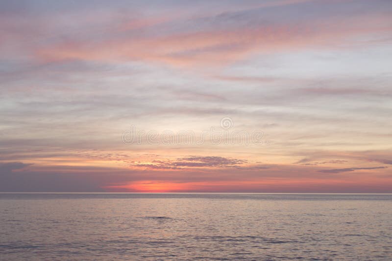 Sea pink sunset. Beautiful color clouds. stock photos