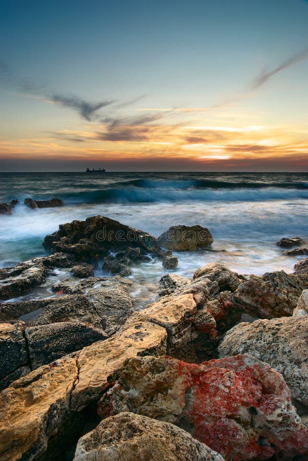 Sea and rock at the sunset