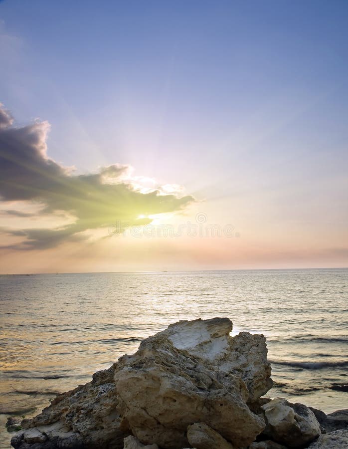 Sea and rock at the sunset.