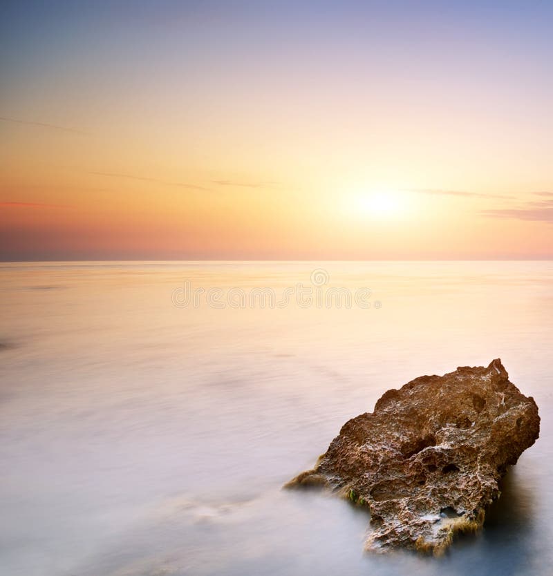 Sea and rock at the sunset