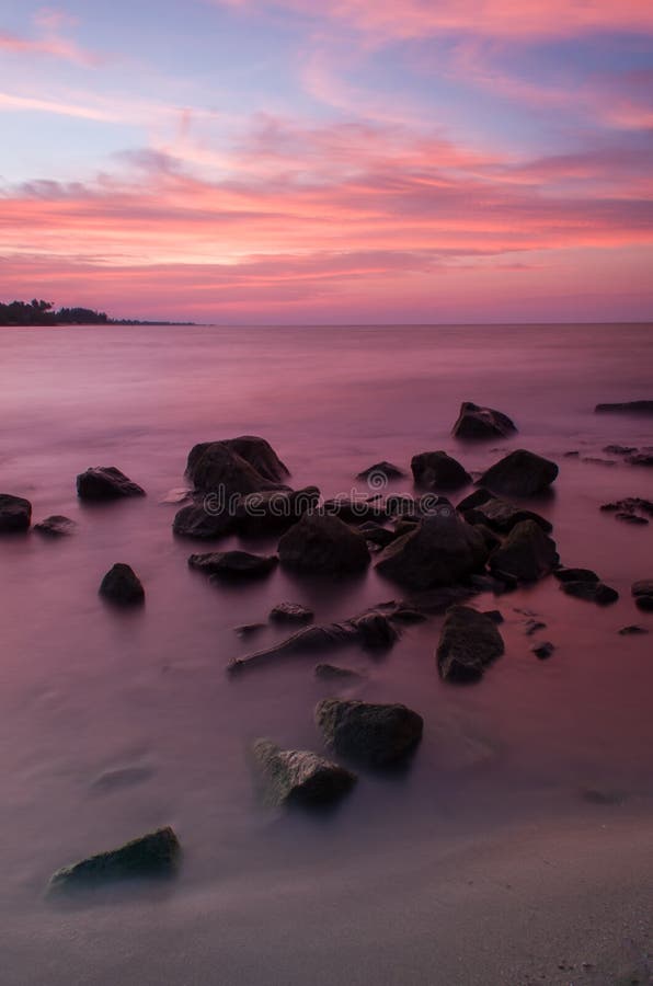 Sea and rock at the sunset. Beautiful nature composition.