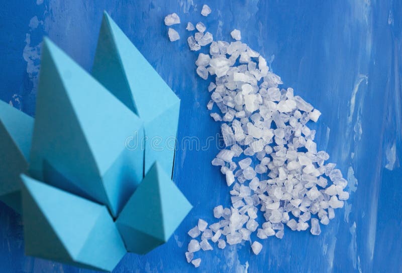 Sea Salt And Crystals Made Of Paper. Blue Background Stock Image
