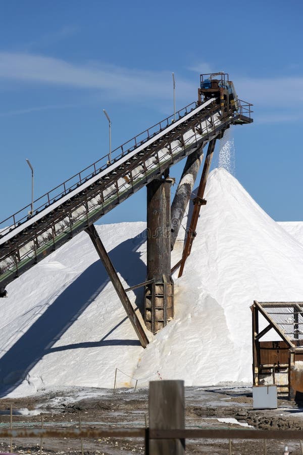 Sea Salt Production and Storage. Conveyor Belt with Salt Stock Photo