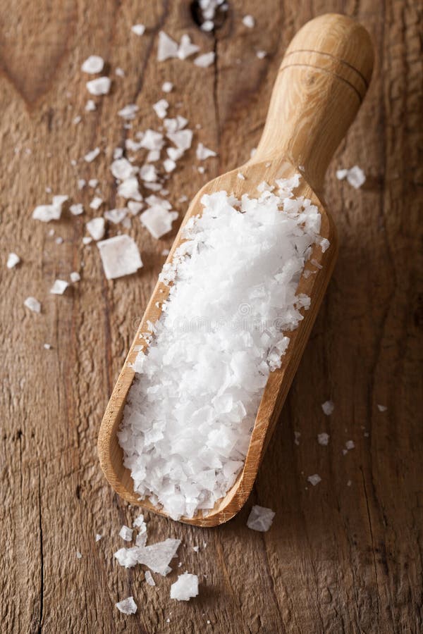 Sea salt in wooden scoop stock photo. image of crystal 34951792