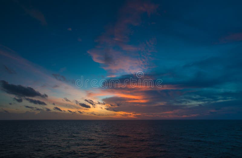 Sea scape, Sun set at sea for background with dark cloud and blue sky in the gulf of Thailand stock images Sea scape, Sun set at sea for background with dark cloud and blue sky in the gulf of Thailand stock images
