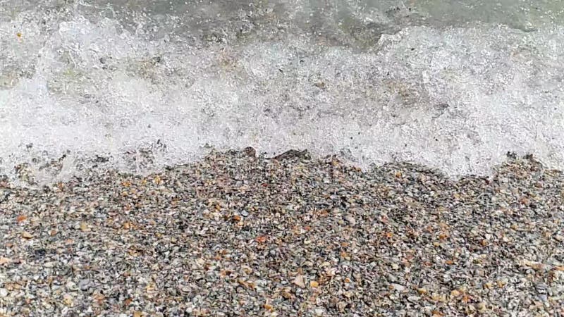 Sea water waves on the beach in slow motion
