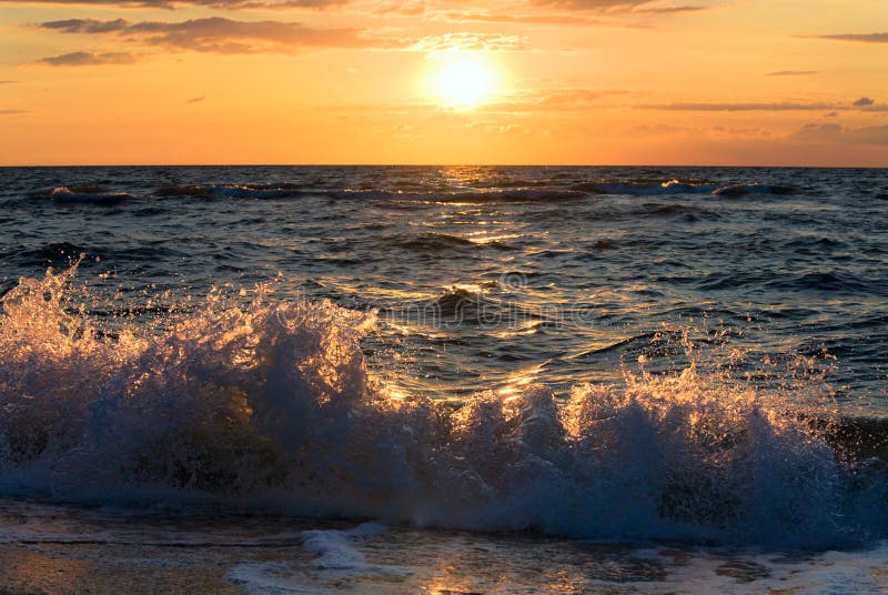 Sea sunset surf wave stock photos