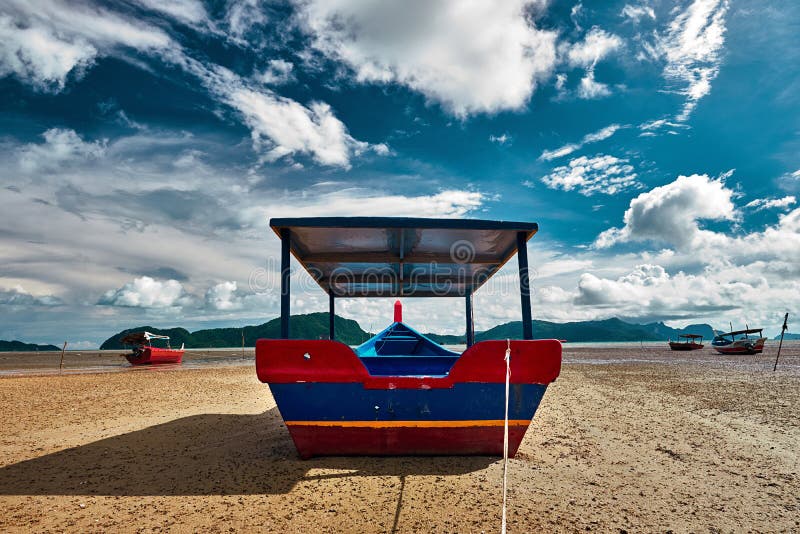 The Sea Tide with a Colorful Asian Fishing Boats and Dramatic Sky on the  Background Stock Photo - Image of tide, asian: 181479058