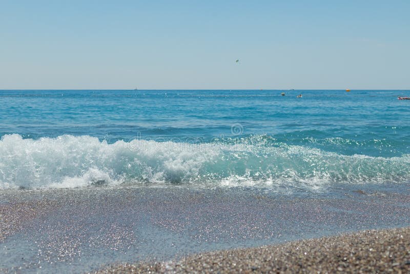 SEA TIDE ON THE PEBBLE BEACH AT SUN LIGHT, BEAUTY OF NATURE, SMALL STONES WITH WATER WAVE IN SUN LIGHT.pebble stones on