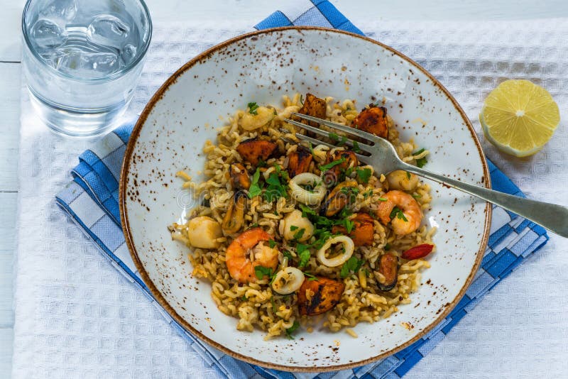 Seafood pilaf or risotto stock photo. Image of dinner 84152726