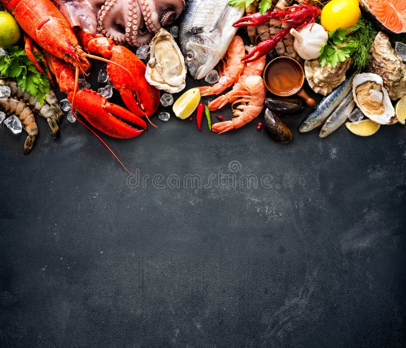 Seafood plate with fresh fish, lobster, mussels, oysters as an ocean gourmet dinner background