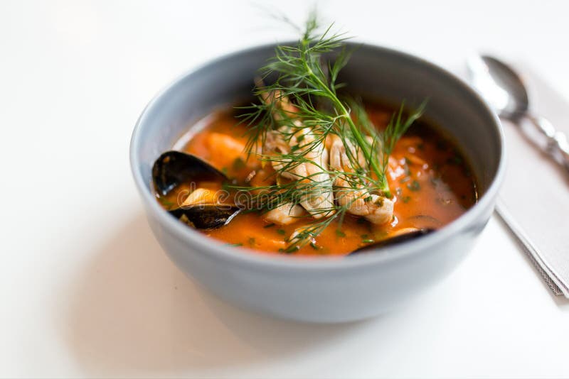 Seafood soup with fish and blue mussels in bowl