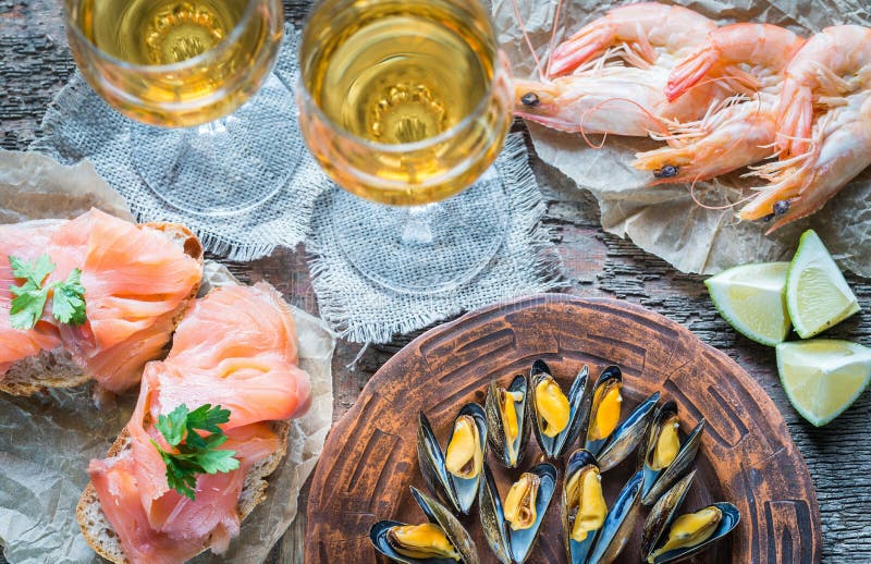 Seafood with Two Glasses of White Wine on the Wooden Table Stock Image