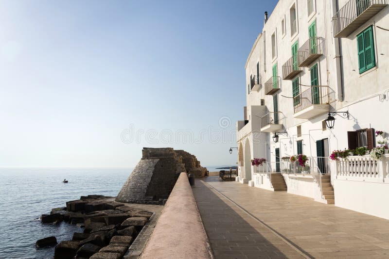 Seafront promede with fortification wall remains in Monopoli, Apulia, Italy
