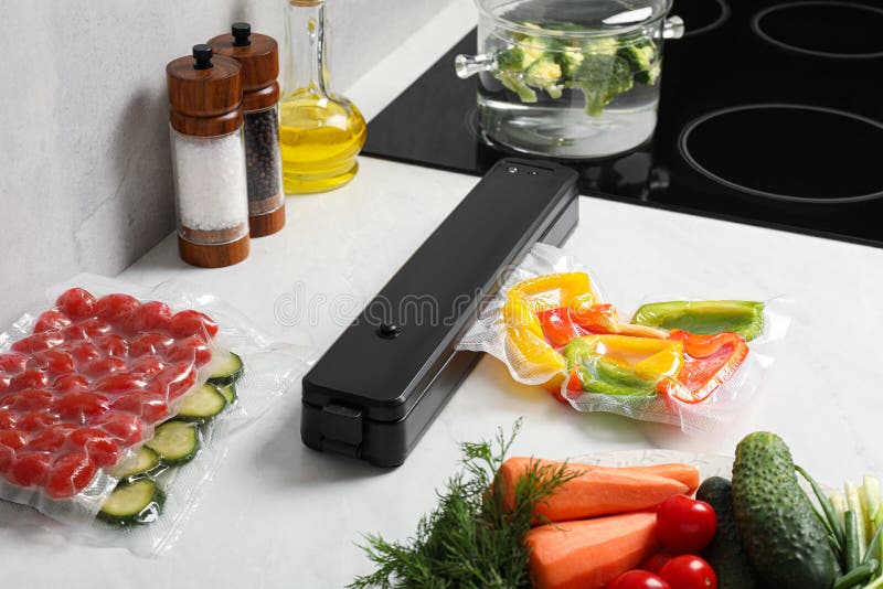 Sealer for Vacuum Packing with Plastic Bag of Bell Pepper on Counter in