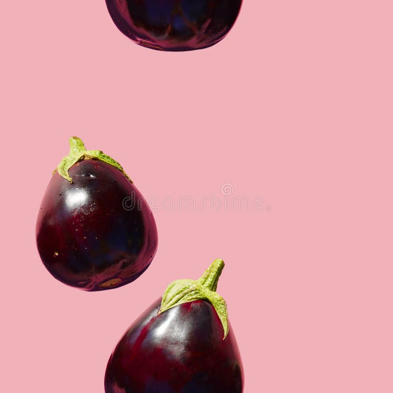 Seamless Eggplants Pattern on a Pink Background. Many Aubergines