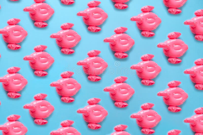 Seamless pattern with Inflatable pink flamingos on a blue background. royalty free stock images