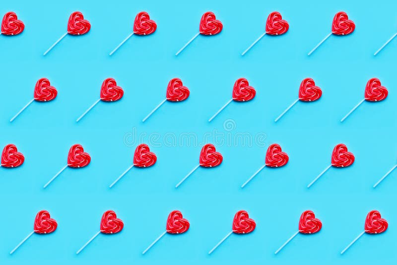 Seamless pattern. Valentines Day bckground. Lollipop candy hearts on blue background. Top view royalty free stock photo Seamless pattern. Valentines Day bckground. Lollipop candy hearts on blue background. Top view royalty free stock photo