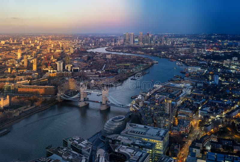 Seamless sunset to night time lapse view of the skyline of London with Tower Bridge and Thames River until Canary Wharf, England