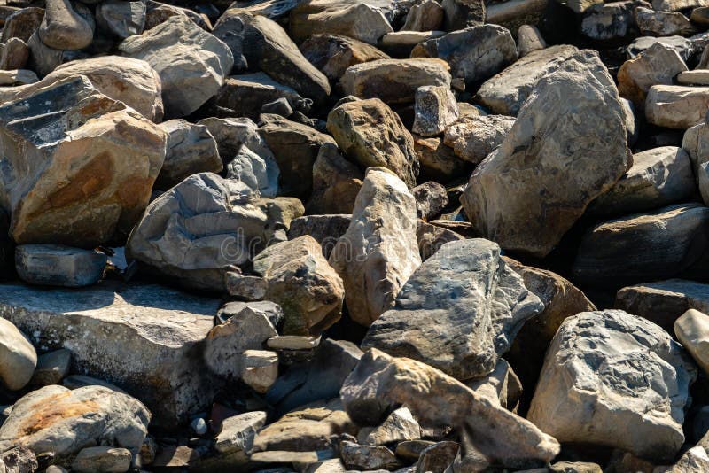 Seamless texture with sea stones and rocks of different sizes as original background. Natural stone of black, gray royalty free stock image Seamless texture with sea stones and rocks of different sizes as original background. Natural stone of black, gray royalty free stock image