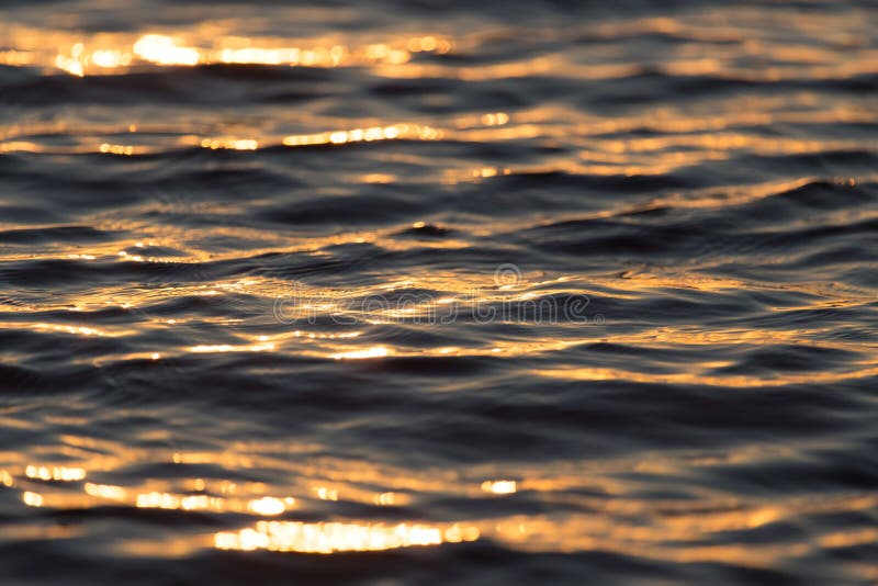 Seamless texture warm color shining sunset water surface. Orange, lake.