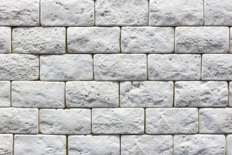Seamless texture of white decorative stacked stone, natural stone cladding. brick background. close up. Background royalty free stock photo