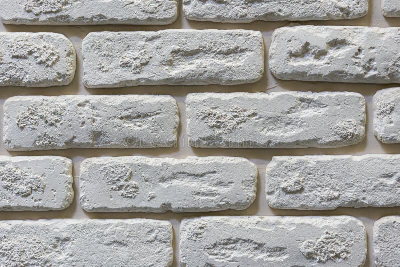 Seamless texture of white decorative stacked stone, natural stone cladding. brick background. close up. Background royalty free stock images