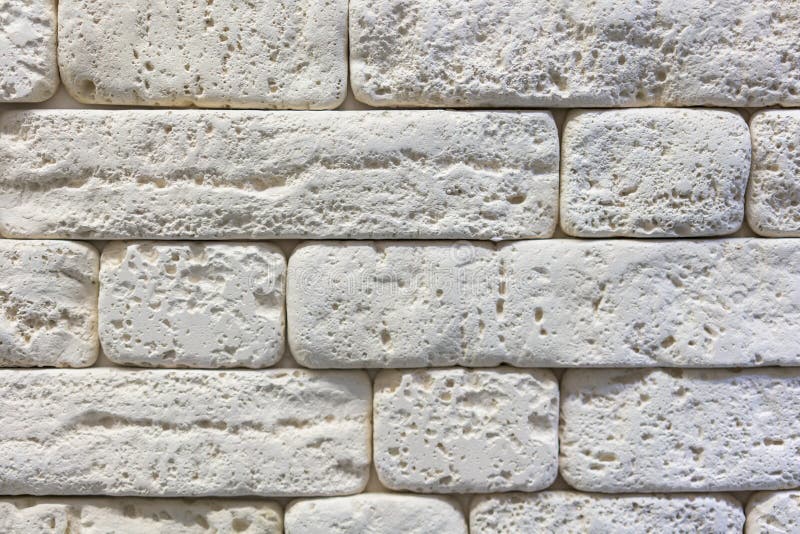 Seamless texture of white decorative stacked stone, natural stone cladding. brick background. close up. Background. toned stock photo
