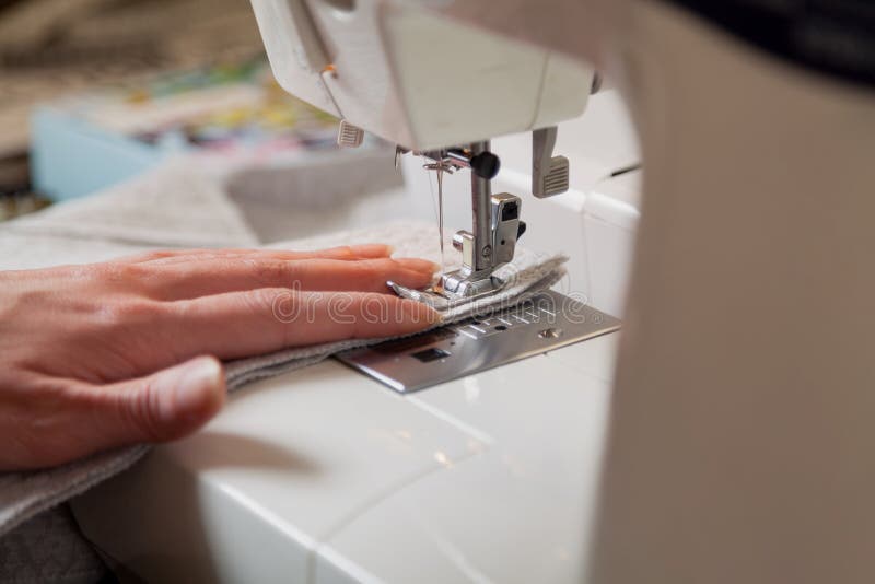 Seamstress Hand Guides Seam on Modern Sewing Machine Stock Photo