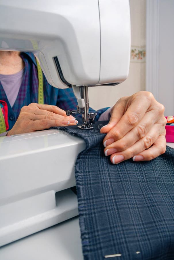 Seamstress Hands Working on a Sewing Machine Stock Photo Image of