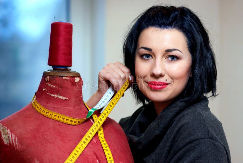 Seamstress with red old mannequin