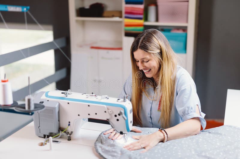 Seamstress Smiling Woman Working with Sewing Machine in Stock