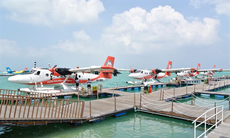 Male, Maldives - February 1, 2016: Trans Maldivian Airways seaplanes are waiting for passengers to board at Male, Maldives. Male, Maldives - February 1, 2016: Trans Maldivian Airways seaplanes are waiting for passengers to board at Male, Maldives