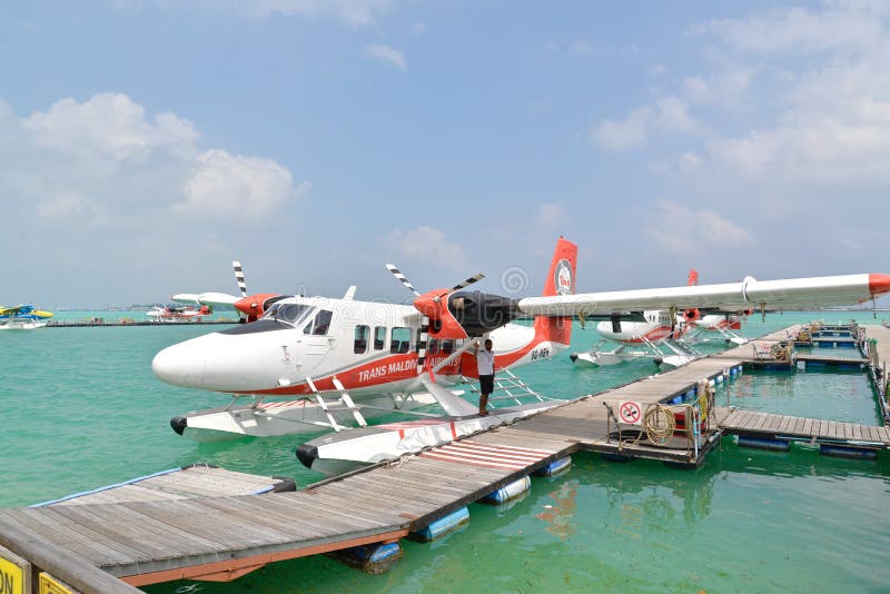Male, Maldives - February 1, 2016: Trans Maldivian Airways seaplanes are waiting for passengers to board at Male, Maldives. Male, Maldives - February 1, 2016: Trans Maldivian Airways seaplanes are waiting for passengers to board at Male, Maldives
