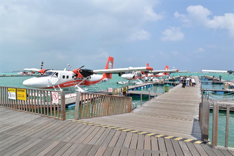 Male, Maldives - February 1, 2016: Passengers are boarding seaplane at Male, Maldives. Male, Maldives - February 1, 2016: Passengers are boarding seaplane at Male, Maldives